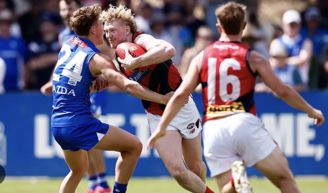 A tackle is laid in heavy traffic during an AFL match