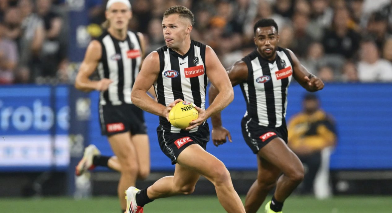 A Collingwood ball-carrier accelerates away from teammates — the young Pies side finding a way through