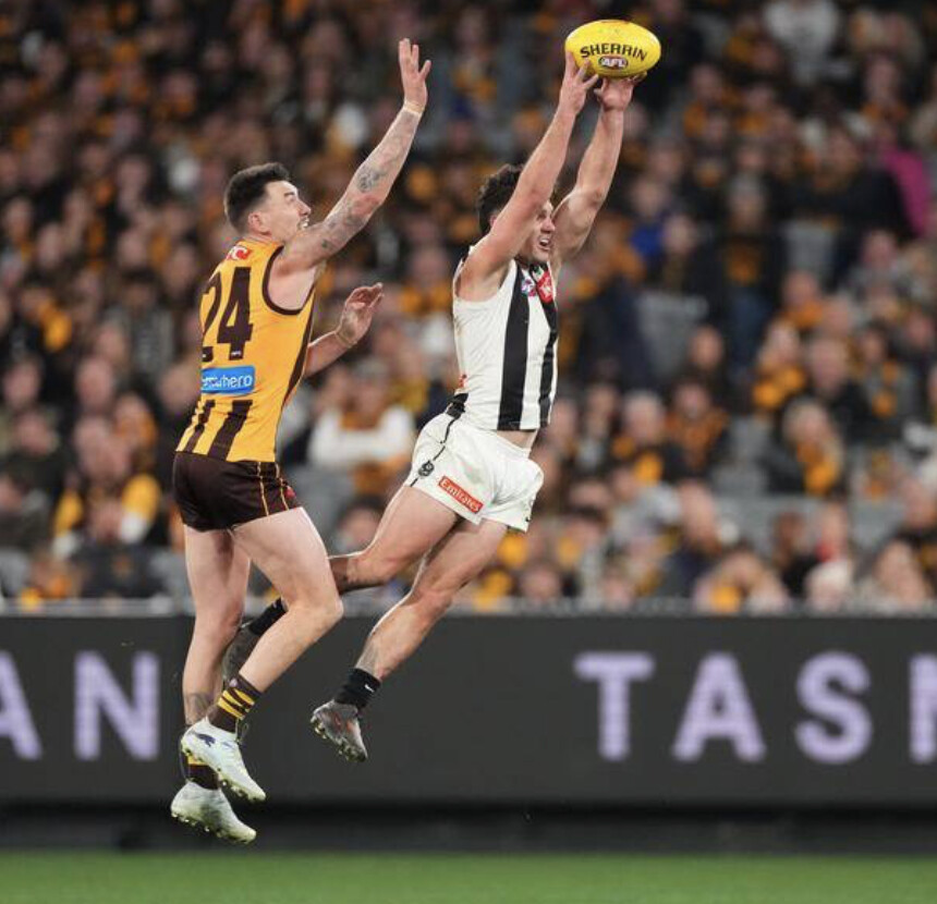 A Collingwood player marks over a Hawthorn opponent — the Magpies carry a battered list into the wildcard round