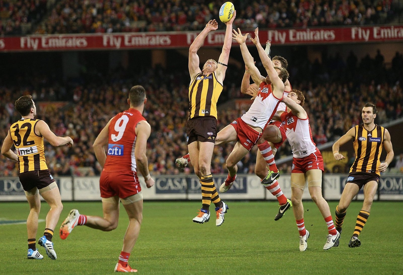 A Hawthorn player out-marks a pack of Sydney defenders — the kind of contested ball that decides tight finals races
