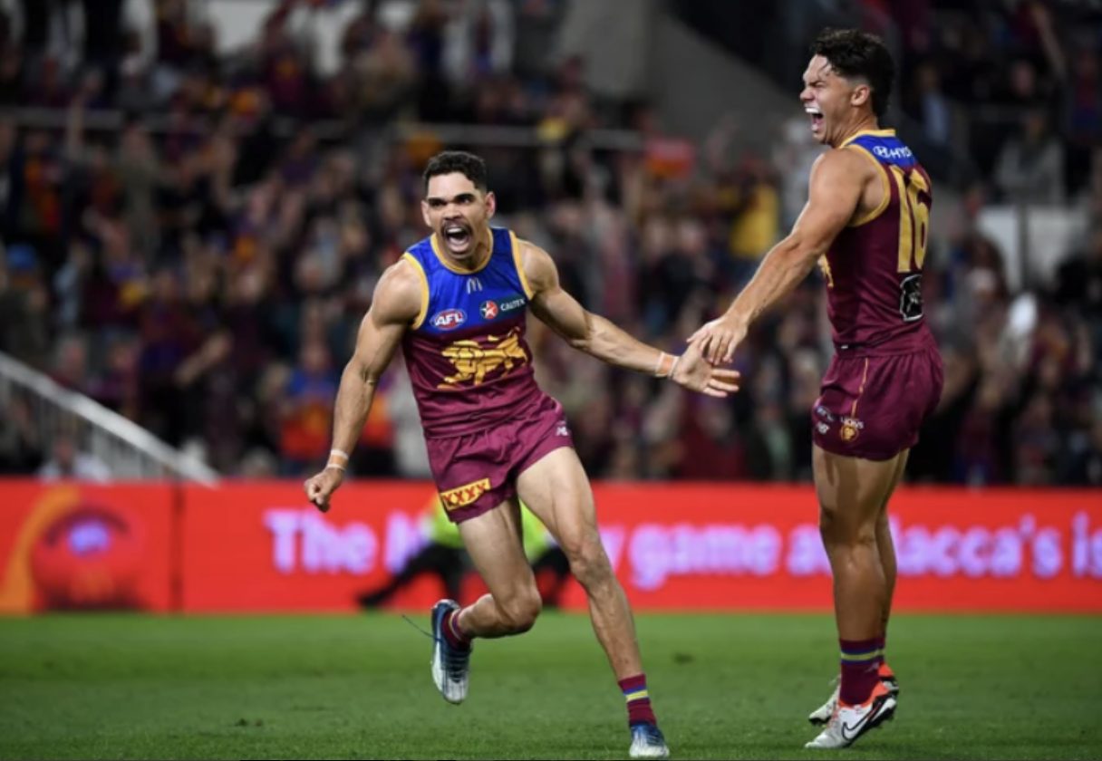 Brisbane Lions players celebrate a goal